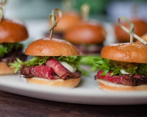 Closeup of Together & Company Tenderloin Button Sliders on a white platter.